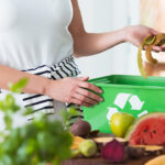 Woman composting organic kitchen waste