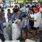 Plastic Bank waste collection partners weighing waste collected from the cleanup